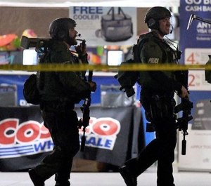 Officers exit the Corona Costco following a shooting inside the wholesale warehouse store on June 14.