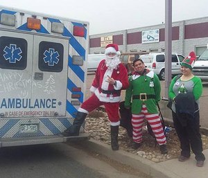 EMTs from Citywide Ambulance dressed up as Santa and elves while assisting patients. (Mercedes Lane Facebook photo)