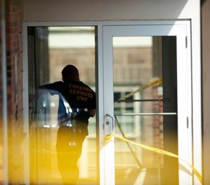 An officer investigates a shooting that occurred in the Masontown borough municipal center on Wednesday, September 19, 2018, in Masontown, Pa. (Andrew Stein/Post-Gazette via AP)