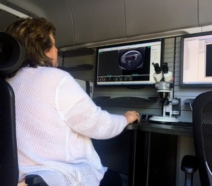 A woman works from a U.S. Bureau of Alcohol, Tobacco, Firearms and Explosives mobile ballistics trailer on Tuesday, May 2, 2017, in Baltimore.
