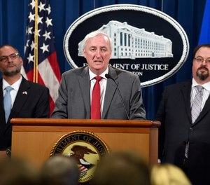 Deputy Attorney General Jeffrey Rosen, center, flanked by Hugh Hurwitz, left, the acting director of the Bureau of Prisons, and David Muhlhausen, director of the National Institute of Justice, speaks during a news conference at the Justice Department in Washington, Friday, July 19, 2019, on developments in the implementation of the First Step Act.