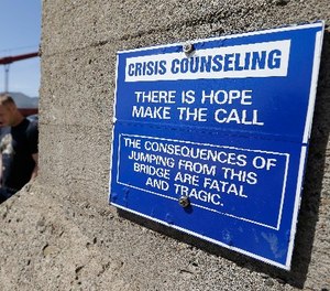 In this file photo taken Tuesday, April 30, 2013, a sign is posted above a crisis counseling call box on the Golden Gate Bridge in San Francisco.