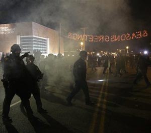 Police officers approach protesters Tuesday, Nov. 25, 2014, in Ferguson, Mo.