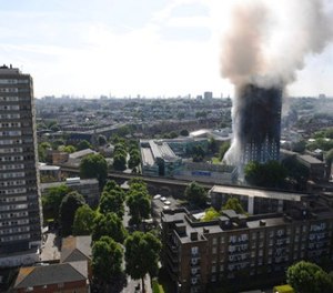 Smoke billows from a fire that has engulfed the 24-storey Grenfell Tower in west London, Wednesday June 14, 2017.