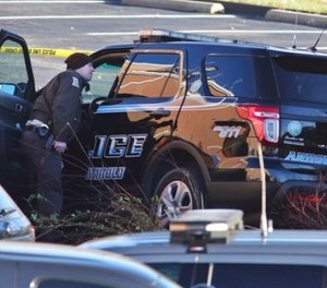 Arnold Police investigate the scene of a shooting of one of their own officers on Tuesday, Dec. 5, 2017, in the parking lot of the Arnold Police Station in Arnold, Mo.