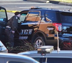 Arnold Police investigate the scene of a shooting of one of their own officers on Tuesday, Dec. 5, 2017, in the parking lot of the Arnold Police Station in Arnold, Mo.