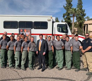 Arizona Gov. Doug Ducey (center) signed into law this month a new initiative to train 700 inmates as wildland firefighters. Ducey met with an all-female inmate fire crew in 2019 to recognize their efforts.
