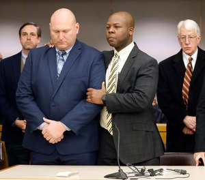 Attorney Keith Harris (center) congratulates former Dallas police officer Christopher Hess (left) as he was found not guilty by a jury in the 292nd District Court at the Frank Crowley Courts Building in Dallas, Thursday, Feb. 13.