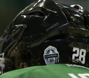 Dallas Stars defenseman Stephen Johns (28) wears a Dallas Police sticker on his helmet during the second period of an NHL hockey game against Anaheim Ducks, Thursday, Oct. 13, 2016, in Dallas. The Stars wore police badge stickers in honor of the law enforcement officers killed in Dallas this past summer.