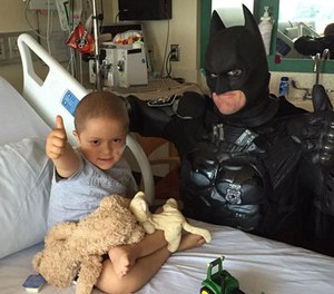 Officer Damon Cole hangs out with 4-year-old Max Brown, who is undergoing treatment for acute lymphoblastic leukemia.