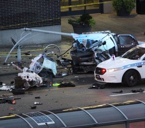 Dayton police work the scene of a crash on East Third Street involving a stolen Riverside police SUV in Dayton, Ohio, Tuesday, Aug. 27, 2019. (Amelia Robinson/Dayton Daily News via AP)