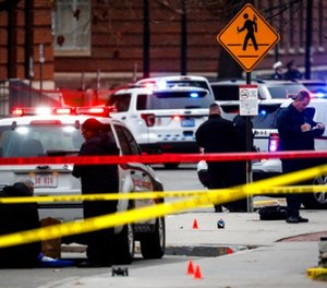 In this Nov. 28, 2016, file photo, crime scene investigators collect evidence from the pavement as police respond to an attack on the Ohio State University campus in Columbus, Ohio.