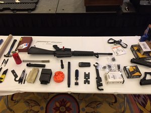 A Vietnam-era AR rifle with some of the parts and tools needed to modernize it.