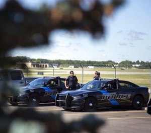 Burton Police Officers gather at Bishop International Airport, Wednesday morning, June 21, 2017, in Flint, Mich. (Shannon Millard/The Flint Journal-MLive.com via AP)