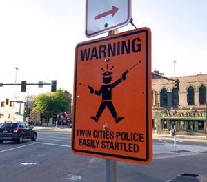 A fake street sign is mounted on the same pole as legitimate ones at the intersection of Cedar and Riverside Aves. Sunday, July 23, 2017, in Minneapolis.