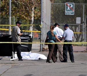 Los Angeles Police Department officers investigate the scene of a shooting Sunday, Aug. 24, 2014, where one person was killed near the 14400 block of Polk Street in Sylmar, Calif.