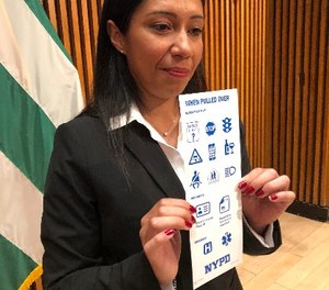 Sgt. Andrea Cruz holds a card that is being sent to nearly 12,000 deaf and hard of hearing motorists. (AP Photo/Michael R. Sisak)