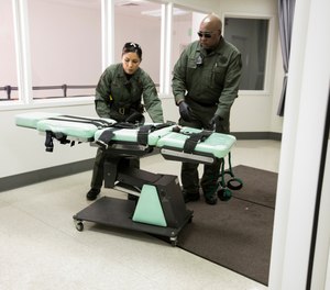 In this photo provided by the California Department of Corrections and Rehabilitation a gurney is removed from the death penalty chamber at San Quentin State Prison, Wednesday, March 13, 2019, in San Quentin, Calif. (California Department of Corrections and Rehabilitation via AP)