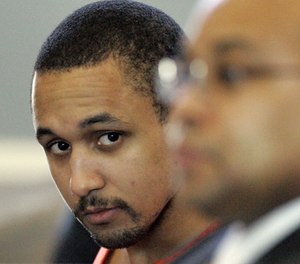 Mikal Deen Mahdi, 23, of Virginia, looks across at his lawyers during his sentencing phase of his trial Monday, Dec.4, 2006, in St. Matthews, S.C. (AP Photo/Mary Ann Chastain)