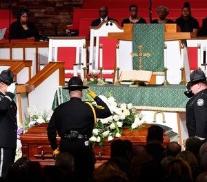 Officers salute the casket during the funeral of Debra Johnson at Temple Church Friday, Aug. 16, 2019, in Nashville, Tenn. Johnson was a former Tennessee Department of Correction administrator slain earlier in the month. (Larry McCormack/The Tennessean via AP, Pool)