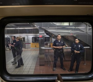 LAPD officers stand guard inside the 7th St/Metro Center subway station in Los Angeles, Calif., on March 26, 2020.