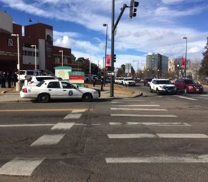 In this photo provided by 9NEWS/KUSA-TV Denver, authorities respond to the scene of a deadly shooting and stabbing at the National Western Complex, Saturday, Jan. 30, 2016, in Denver. (9NEWS/KUSA-TV Denver via AP)