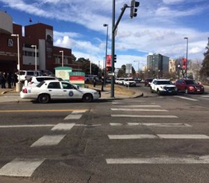 In this photo provided by 9NEWS/KUSA-TV Denver, authorities respond to the scene of a deadly shooting and stabbing at the National Western Complex, Saturday, Jan. 30, 2016, in Denver.