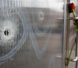 Bullet holes are seen in the window of the cultural center one of the locations of the weekend shootings in Copenhagen, Denmark, Tuesday, Feb. 17, 2015. (AP Image)