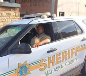 Deputy Brian Rainey sits in a Mahaska County Sheriff's Office vehicle.