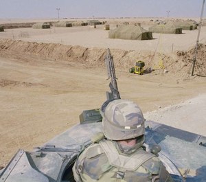 U.S. soldiers on guard over 7th corps enemy prisoners of war holding area, Feb. 12, 1991, in central Saudi Arabia during Operation Desert Storm.