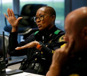 In this June 22, 2017, photo, Dallas police Sgt. Bridget Wilson-Jones adds to a discussion related to a task during a training session at the Center for Brain Health in Dallas.