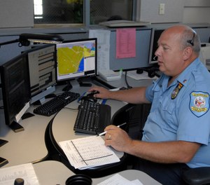 This July 14, 2009 photo shows senior dispatcher Ken Marks working at the Albany Police Department call center in Albany, N.Y.