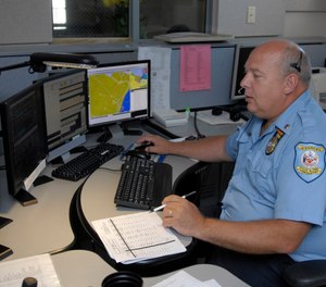 This July 14, 2009 photo shows senior dispatcher Ken Marks working at the Albany Police Department call center in Albany, N.Y.