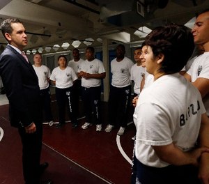 In this Wednesday, June 17, 2015, Jersey City Mayor Steven Fulop, left, talks to police department officers during a training session in Jersey City, N.J.
