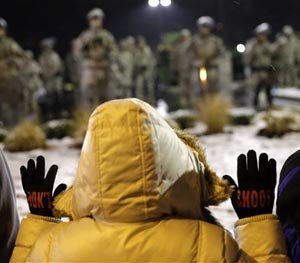 Margaret Morrow stands with others in front of the Ferguson Police Department Wednesday, Nov. 26, 2014, in Ferguson, Mo. (AP Image)