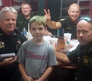 This picture captures Tyler Carach posing with the very first LEOs he gave donuts to.