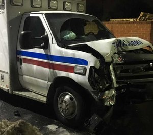 The patient hit two police vehicles with the ambulance before crashing into a tree. (Photo/YouTube)