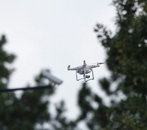 Police officers survey the scene via a drone at a Wells Fargo Bank, Friday, July 7, 2017 in Marietta, Ga.