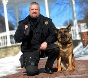 In this Feb. 24, 2015, file photo, Ligonier Township, Pa., Police Department Lt. Eric Eslary poses for a photo with his K-9 partner Blek in Ligonier, Pa. (Evan Sanders/Pittsburgh Tribune-Review via AP, File)