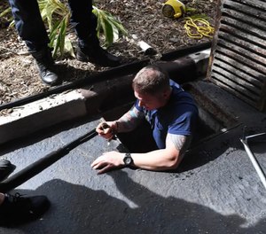 Firefighters with the Bradenton Fire Department proved to be the silver lining of the storm drain stowaway’s day. (Photo/Screen shot, Tiffany Tompkins video)
