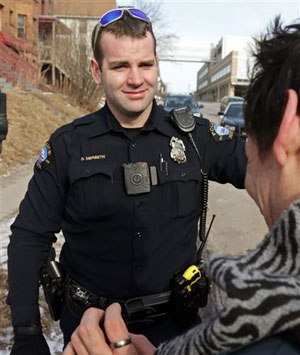 A red light on the body camera worn on Duluth, Minn. police officer Dan Merseth's uniform indicates it is active prior to taking a man, right, to a detox center.
