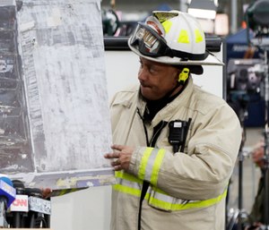 Oakland Fire Battalion Chief Darin White shows an aerial view of a warehouse fire.