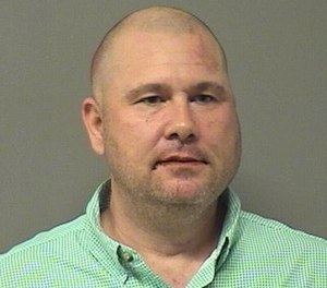 Bentonville Fire Capt. Benjamin Snodgrass is accused of a racist assault on an Asian man earlier this month.