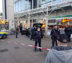 A car stands in front of a store, guarded by police in Heidelberg, Germany, Saturday, Feb. 25, 2017.