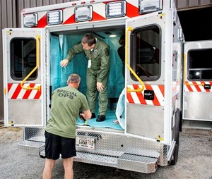 Grady EMS Commander Aaron Jamison (left) and Grady EMS Interim Director Wade Miles prepare for the transport of Dr. Kent Brantly, the first Ebola-infected American aid worker who was brought from Africa to Emory University Hospital in Atlanta, Ga. for treatment. (Image Grady EMS)