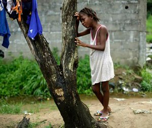 FILE - In this Thursday Oct. 2, 2014 file photo, Mercy Kennedy, 9, cries as she learned her mother has died, outside her home in Monrovia, Liberia. On the day Mercy Kennedy lost her mother to Ebola, it was hard to imagine a time Liberia would be free of one of the world’s deadliest viruses. It had swept through the 9-year-old’s neighborhood, killing people house by house. Now seven months later, Liberia on Saturday officially marked the end of the epidemic that claimed more than 4,700 lives here, and Mercy is thriving in the care of a family friend not far from where she used to live. (AP Photo/Jerome Delay,File)