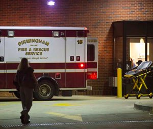 An ambulance sits outside the University of Alabama at Birmingham Hospital emergency room where a patient with possible Ebola symptoms was admitted, Tuesday, Aug. 4, 2015, in Birmingham, Ala. Officials say a quarantine is in place at a Birmingham home over concerns about the possible case of the Ebola virus. Jefferson County Medical Director Edward Khan says the patient recently traveled to a country with active Ebola cases, but he didn't identify the country or name the patient. (AP Photo/Brynn Anderson)
