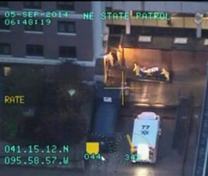 In this frame grab made from video which was released by the Nebraska State Patrol, Dr. Rick Sacra, 51, who was infected with Ebola while serving as a family doctor in Liberia is taken on a gurney by two persons wearing protective gear, as he arrives to the Nebraska Medical Center in Omaha, Neb., Friday Sept. 5, 2014. Sacra, who served with North Carolina-based charity SIM, is the third American aid worker infected by the Ebola virus. (AP Photo/Nebraska State Patrol)
