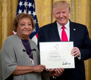 In this Sept. 9, 2019, file photo, President Donald Trump presents a Certificate of Commendation to Minnie Grant, the mother of Christopher Grant, one of five civilians celebrated for their heroism during a mass shooting in El Paso, Texas, at a ceremony in the East Room of the White House in Washington. (AP Photo/Andrew Harnik, File)