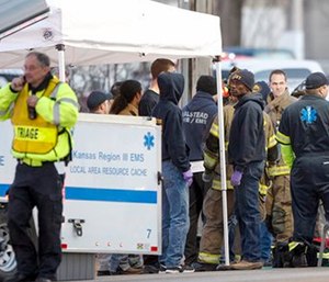 Responders gather near a staging area by Excel Industries in Hesston, Kan.